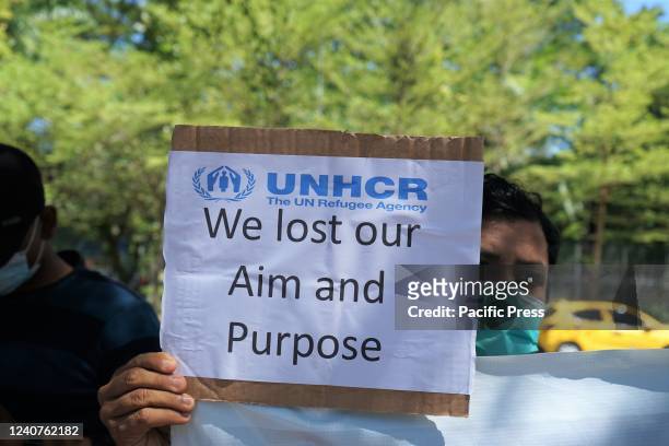 Rohingya refugee holding placard participates in a protest. Hundreds of Rohingya refugees from Myanmar who have lived in Indonesia for a dozen years...