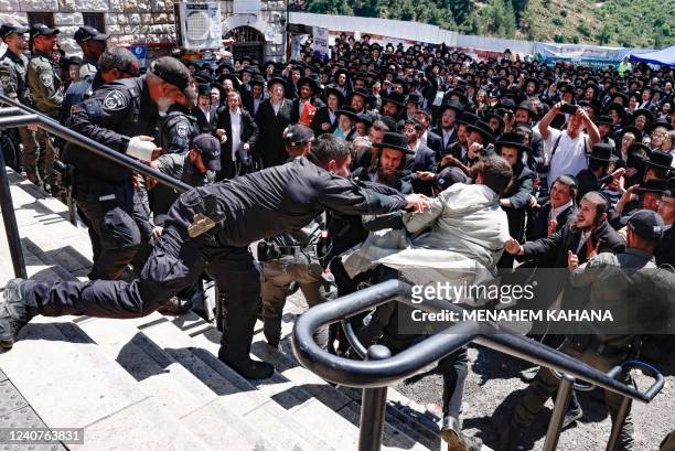 Ultra-Ortodox Jews scuffle with the police as they try to enter the grave site of Rabbi Shimon Bar Yochai in the northern Israeli village of Meron,...