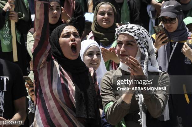 Palestinian students supporting the Islamic Hamas movement celebrate a victory in student elections at Birzeit University on the outskirts of...