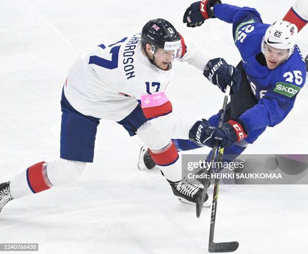 Britain's defender Mark Richardson and USA's forward Karson Kuhlman vie for the puck during the IIHF Ice Hockey World Championships 1st Round group B...