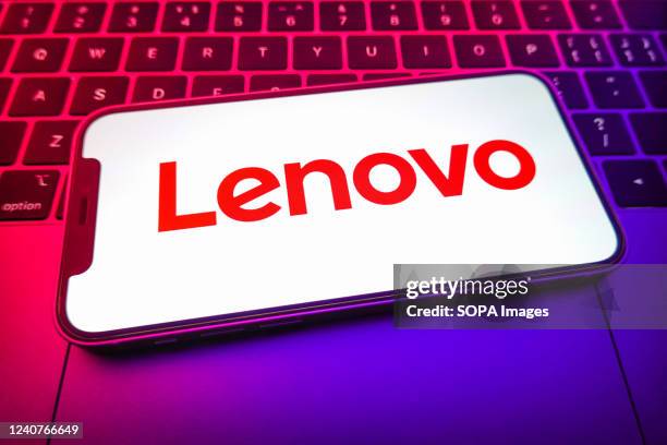 In this photo illustration, a Lenovo logo is displayed on the screen of a smartphone.