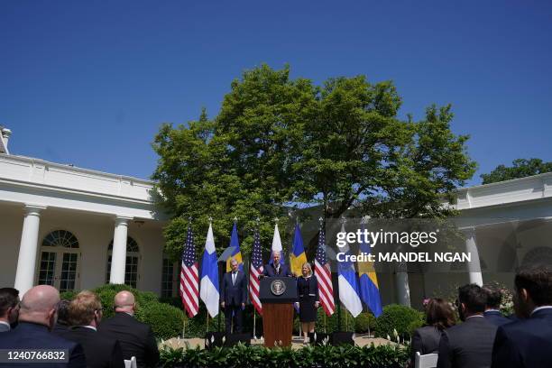 President Joe Biden, flanked by Sweden's Prime Minister Magdalena Andersson and Finland's President Sauli Niinistö, speaks in the Rose Garden...