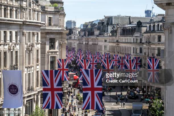 British Union Jack flags are displayed along Regent Street to mark the forthcoming Platinum Jubilee of Queen Elizabeth II, on May 19, 2022 in London,...