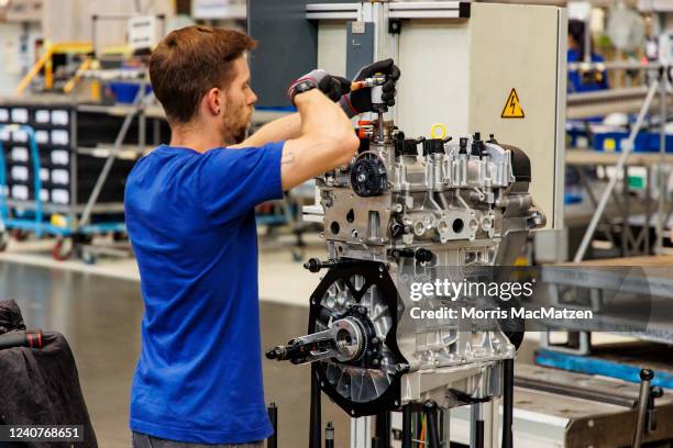 Volkswagen employee assembles a combustion engine at the Volkswagen plant on May 18, 2022 in Salzgitter, Germany. The new SalzGiga facility will...