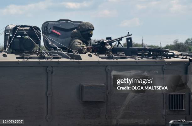 Russian servicemen are seen on a roadside in the Kherson region on May 19 amid the ongoing Russian military action in Ukraine.