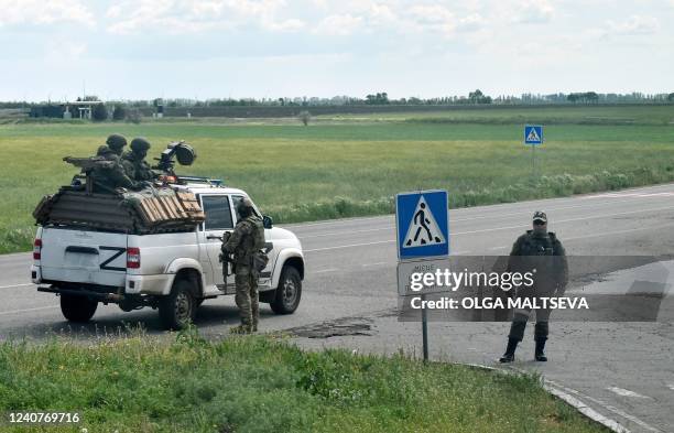 Russian servicemen are seen on a roadside in the Kherson region on May 19 amid the ongoing Russian military action in Ukraine.