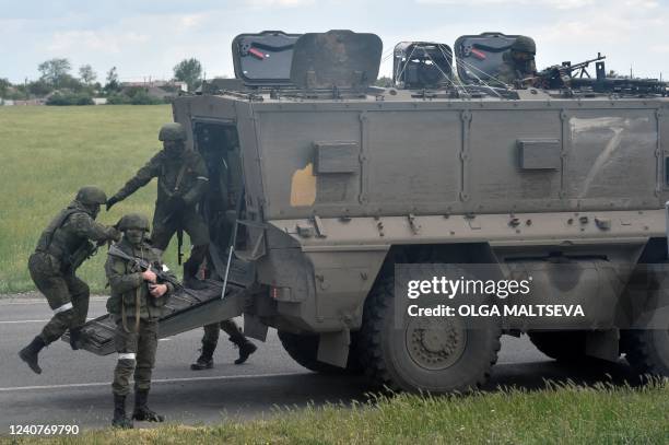 Russian servicemen are seen on a roadside in the Kherson region on May 19 amid the ongoing Russian military action in Ukraine.