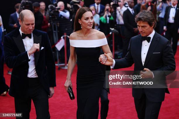 Britain's Prince William, Duke of Cambridge and Britain's Catherine, Duchess of Cambridge are accompanied by US actor Tom Cruise as they arrive for...