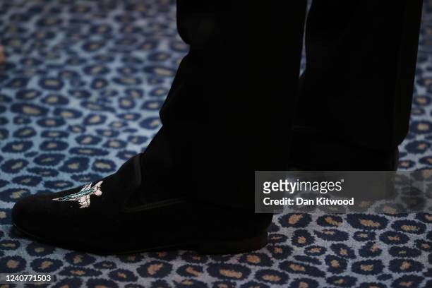 Prince William, Duke of Cambridge wears a pair of shoes embroidered with a fighter aircraft logo for the "Top Gun: Maverick" Royal Film Performance...
