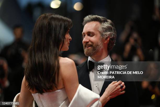 Actress Anne Hathaway and her husband Adam Shulman leave the Festival Palace following the screening of the film "Armageddon Time" during the 75th...