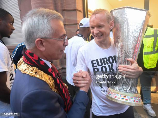 Frankfurt's Sebastian Rode carries the trophy and is welcomed by Frankfurt's Lord Mayor Peter Feldmann during the official celebration of winning the...