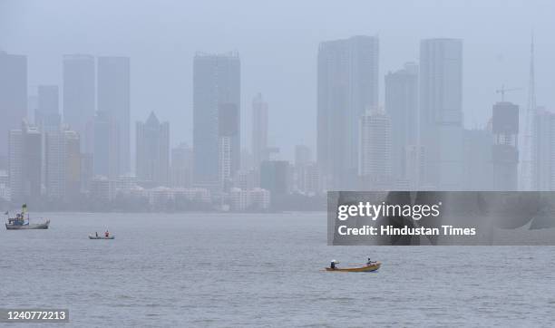 Fishermen go for a fishing in their boats in the Arabian Sea engulfed by hazy weather, on May 19, 2022 in Mumbai, India,.