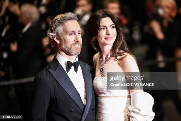 Actress Anne Hathaway and her husband Adam Shulman pose as they leave the Festival Palace following the screening of the film "Armageddon Time"...
