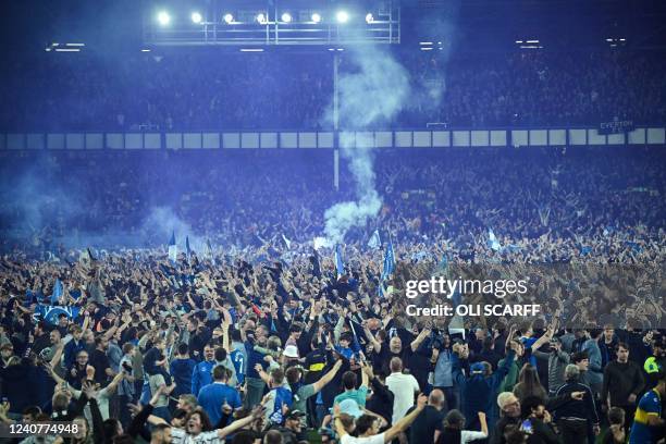 Everton's fans invade the football pitch to celebrate at the end of the English Premier League football match between Everton and Crystal Palace at...