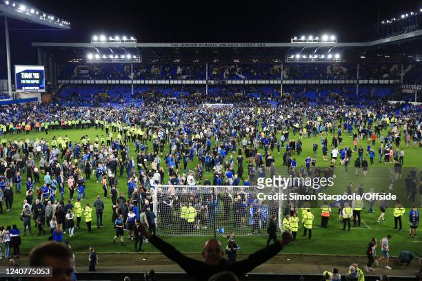 Everton fans celebrate with a pitch invasion after the Premier League match between Everton and Crystal Palace at Goodison Park on May 19, 2022 in...