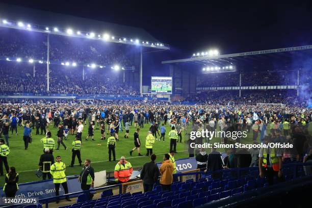 Everton fans celebrate with a pitch invasion after the Premier League match between Everton and Crystal Palace at Goodison Park on May 19, 2022 in...