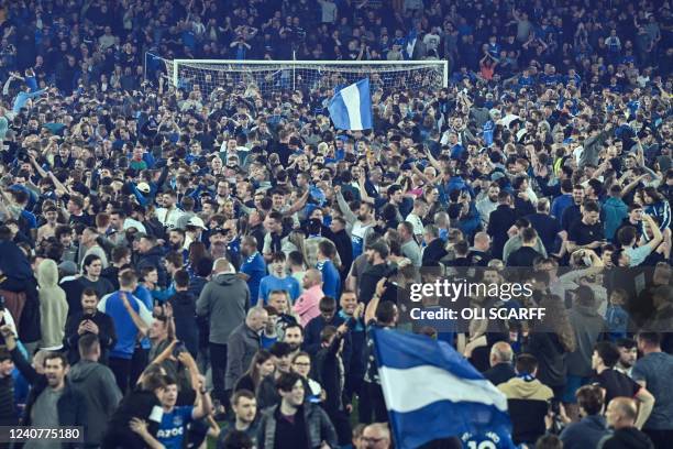 Everton's fans invade the football pitch to celebrate at the end of the English Premier League football match between Everton and Crystal Palace at...