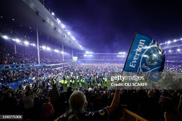 Everton's fans invade the football pitch to celebrate at the end of the English Premier League football match between Everton and Crystal Palace at...