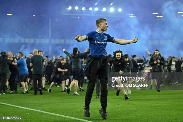 Everton's fans invade the football pitch to celebrate at the end of the English Premier League football match between Everton and Crystal Palace at...