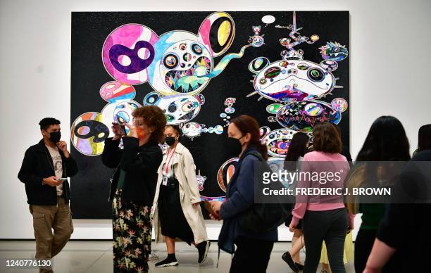 An acrylic on canvas "Double Helix within Dark Matter" by Maurice Marciano on display as people attend the press preview of Takashi Murakami's...