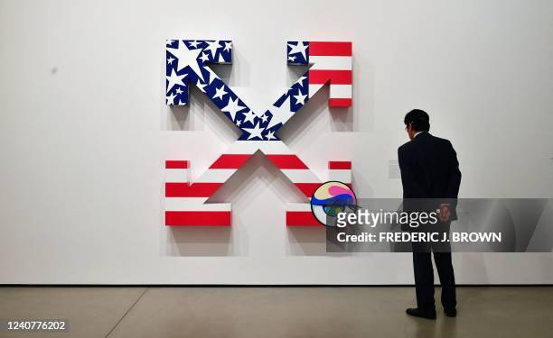 Man views a collaboration piece by Takashi Murakami and Virgil Abloh titled "Times: America Too" acrylic on canvas at the "This Is Not America's...