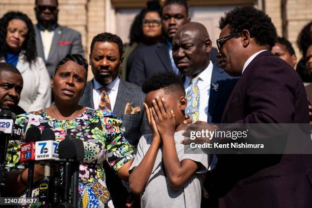 Jacob Patterson center, the son of the late Deacon Hayward Patterson, is comforted by Garnell Whitfield Jr., while his mother, Tirzah Patterson,...