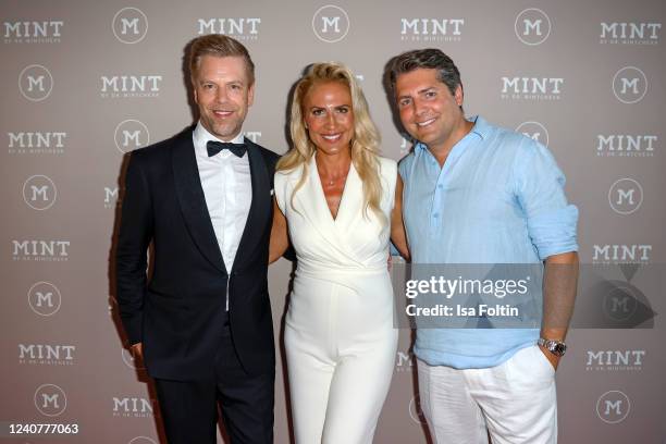 Tom Gaebel, Mariana Mintcheva, Baptiste Pawlik during the opening of Germany's first dental spa by celebrity doctor Mariana Mintcheva on May 19, 2022...
