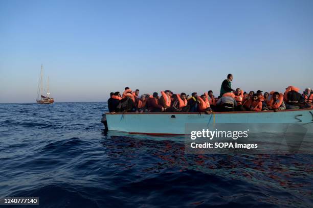 Migrants seen on a wooden boat. The crew of Astral sailboat, of the Spanish NGO Open Arms, carried out a rescue for nearly 70 women and men in...