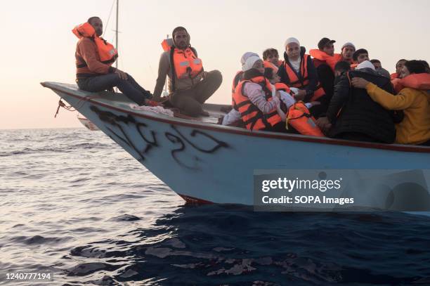 Women seen on board of a migrant boat in distress. The crew of Astral sailboat, of the Spanish NGO Open Arms, carried out a rescue for nearly 70...
