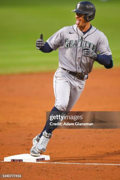 Dylan Moore of the Seattle Mariners reacts as he rounds third base after hitting a three-run home run in the second inning of a game against the...