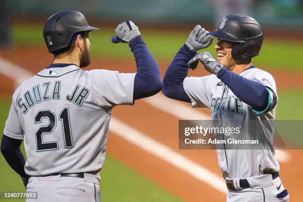 Dylan Moore reacts with Steven Souza Jr. #21 of the Seattle Mariners after hitting a three-run home run in the second inning of a game against the...