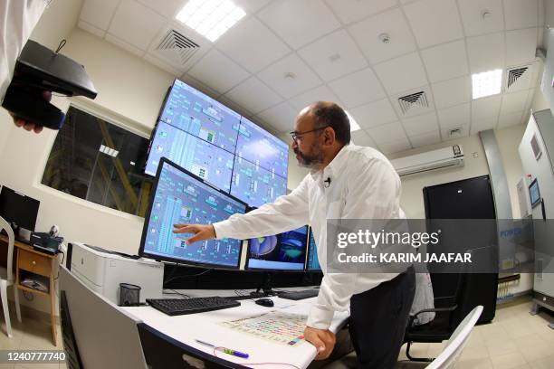 Saud Abdulaziz Abdul Ghani displays readings on a screen during a tour of the cooling system at the al-Janoub Stadium on April 20, 2022 in Doha,...