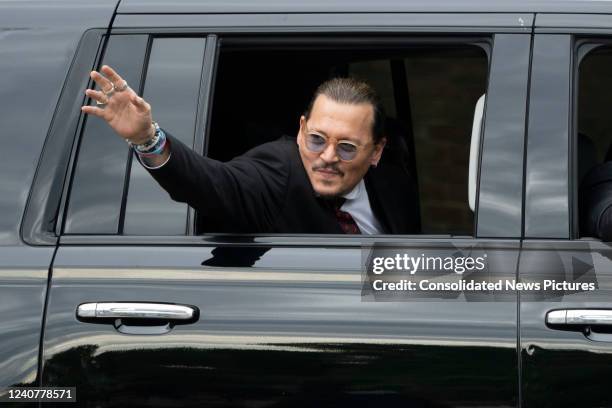 Actor Johnny Depp waves to his fans as he departs outside court during the Johnny Depp and Amber Heard civil trial at Fairfax County Circuit Court on...