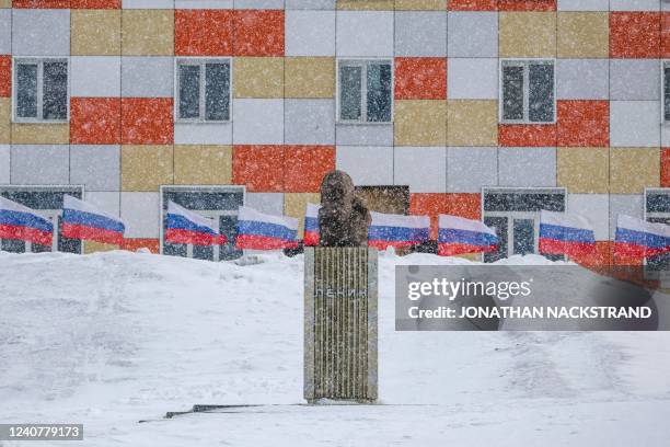 Monument to Lenin is pictured during blizzard as Russian flags flap in the background on May 7 in the miners' town of Barentsburg, on the Svalbard...