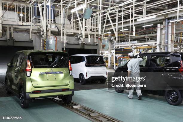 Mitsubishi Motors Corp. EK X electric vehicle , left, and a Nissan Motor Co. Sakura electric vehicle , center, in the inspection area of the...