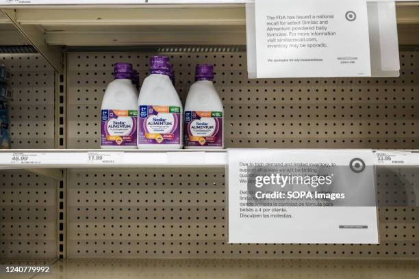 Sign on a nearly empty shelf informs customers that baby formula sales are limited to four units per child at a Target store. Baby formula has been...