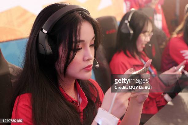This photograph taken on May 18, 2022 shows Vietnamese esport women's team member Le Tra My preparing before the Esport League Of Legends: Wild Rift...