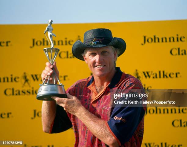 Greg Norman of Australia celebrates with the trophy after winning the Johnnie Walker Classic at the Blue Canyon Country Club on February 6, 1994 in...