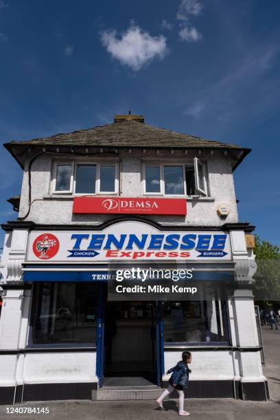 Young girl outside Tennessee Express chicken and burger fast food restaurant in Turnpike Lane in Wood Green on 19th May 2022 in London, United...