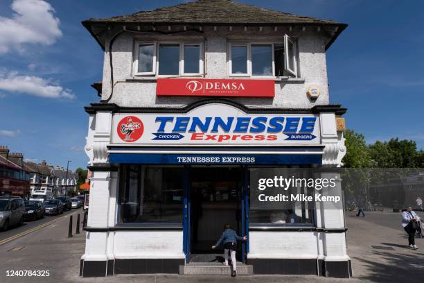 Young girl outside Tennessee Express chicken and burger fast food restaurant in Turnpike Lane in Wood Green on 19th May 2022 in London, United...
