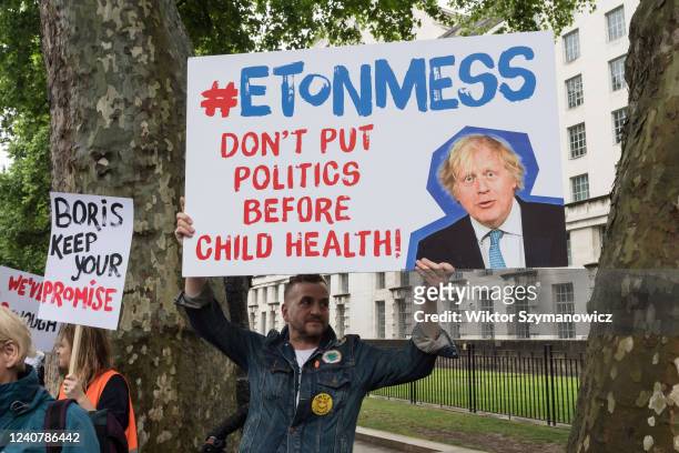 Members of the public gather outside Downing Street in a protest against the government's U-turn on its anti-obesity strategy on May 20, 2022 in...