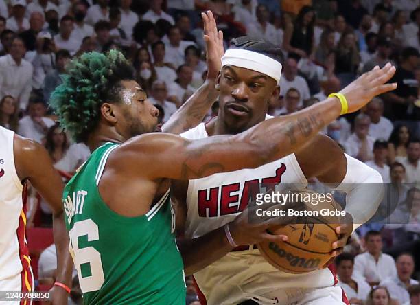 Miami Heat forward Jimmy Butler drives to the basket on Boston Celtics guard Marcus Smart during first quarter of game 2. The Miami Heat host the...