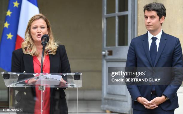 Former Government's spokesperson Gabriel Attal listens the speech of his successor Olivia Gregoire during the ceremony of the government reshuffle in...