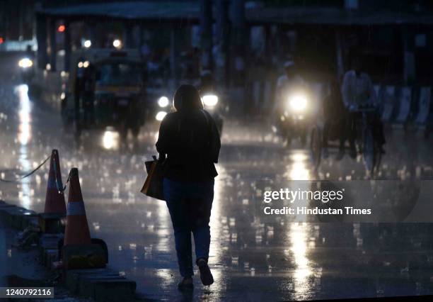 Commuters on Delhi-Gurugram Expressway near IFFCO Chowk amid light rains on May 20, 2022 in Gurugram, India. The people of Delhi, who have been...