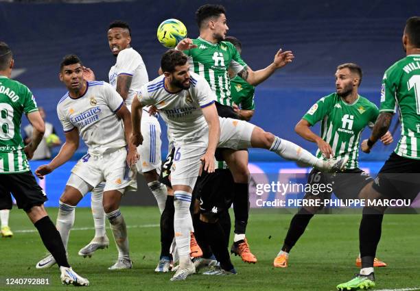 Real Madrid's Spanish defender Nacho Fernandez vies for a header with Real Betis' Spanish defender Marc Bartra during the Spanish league football...