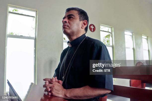 Nicaraguan Catholic bishop Rolando Alvarez prays at the Santo Cristo de Esquipulas church in Managua, on May 20, 2022. - Alvarez, a strong critic of...