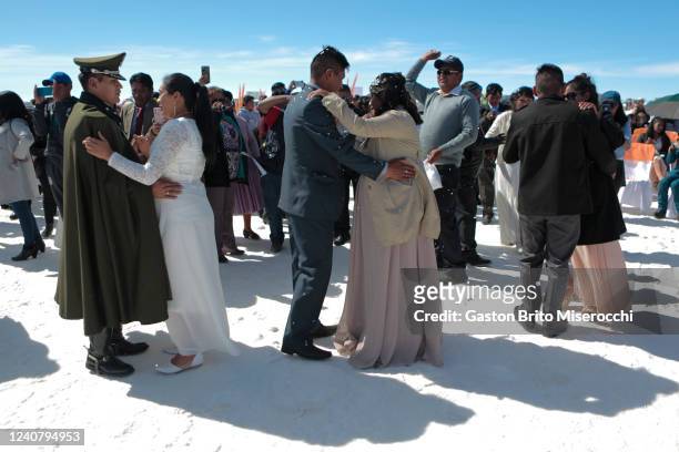 Couples dance during a mass wedding for 34 couples at Uyuni Salt Flats on May 20, 2022 in Uyuni, Bolivia. The civil registration organized an open...