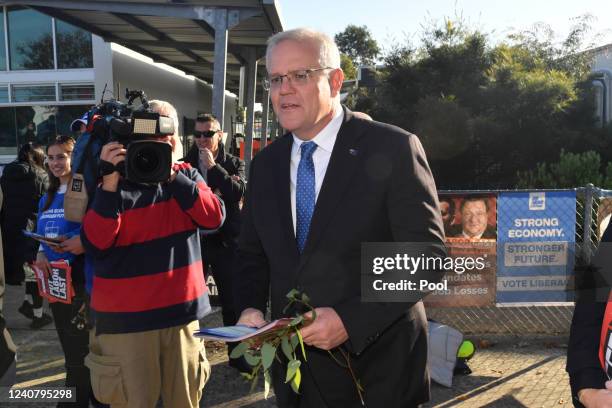 Prime Minister Scott Morrison hands out fliers at the Laurimar Primary School on Federal Election day, in Doreen on May 21, 2022 in Melbourne,...