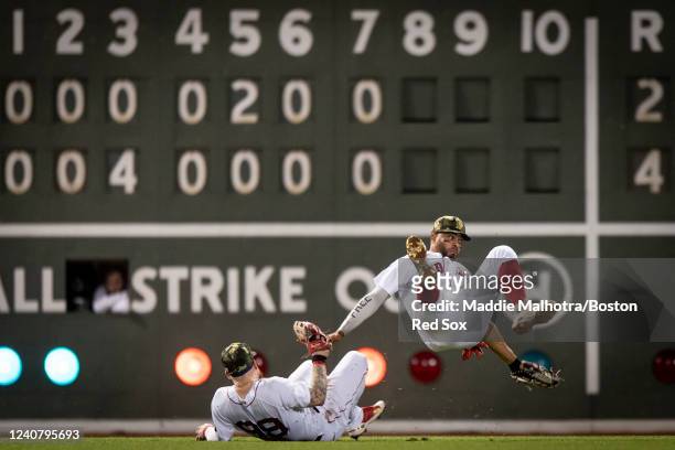 Xander Bogaerts of the Boston Red Sox collides with Alex Verdugo of the Boston Red Sox while attempting to catch a fly ball during the eighth inning...