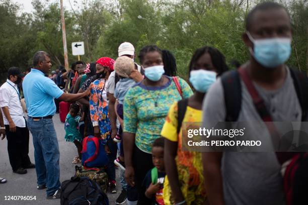 Mostly Haitian migrants wait to board a bus taking them from a shelter to a US port of entry to start legal paperwork in Reynosa, Tamaulipas state,...